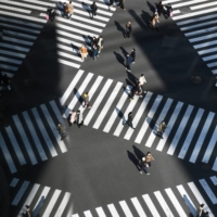 Pedestrians cross an intersection in the Ginza area of Tokyo on Saturday. Japan is starting to see a decline in new COVID-19 cases. | BLOOMBERG