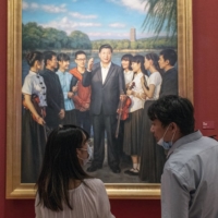Visitors in front of a portrait of Xi Jinping at the National Art Museum in Beijing during the exhibition “100 years toward greatness” in June, 2021. A century after the Communist Party’s founding, Xi Jinping, China’s leader, said foreign powers would “crack their heads and spill blood” if they tried to stop its rise.  | GILLES SABRIZ / THE NEW YORK TIMES