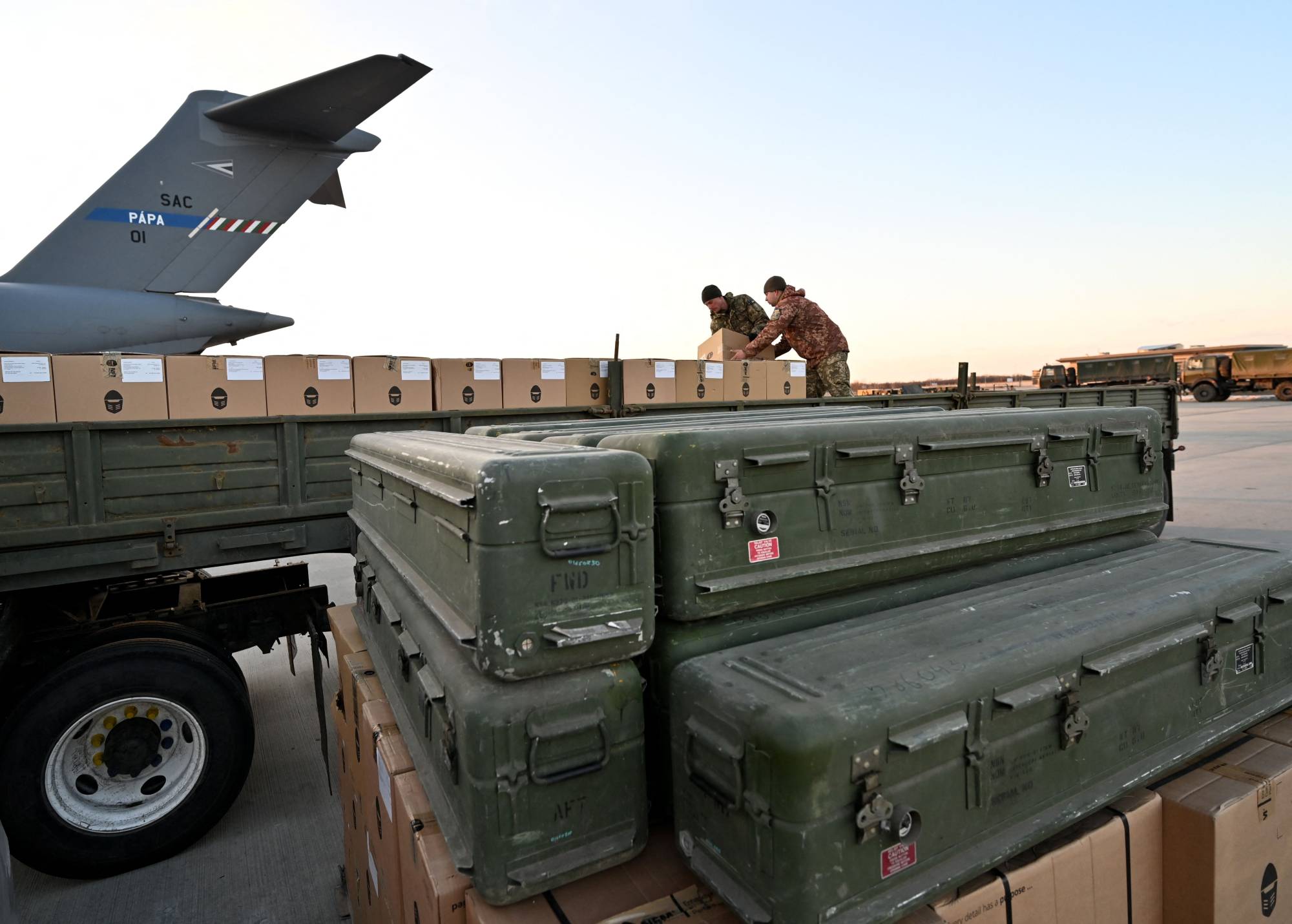 Ukrainian Military servicemen load a flatbed truck with boxes of U.S.-made weaponry at Boryspil Airport, near Kyiv, on Sunday. | AFP-JIJI