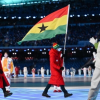 Ghana\'s flag bearer Carlos Maeder takes part in the parade of athletes during the opening ceremony of the 2022 Beijing Winter Olympics at the National Stadium on Feb. 4. | AFP-JIJI