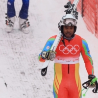 Shannon Abeda of Eritrea departs the slope after his men\'s giant slalom run at the 2022 Beijing Winter Olympics on Sunday. | REUTERS