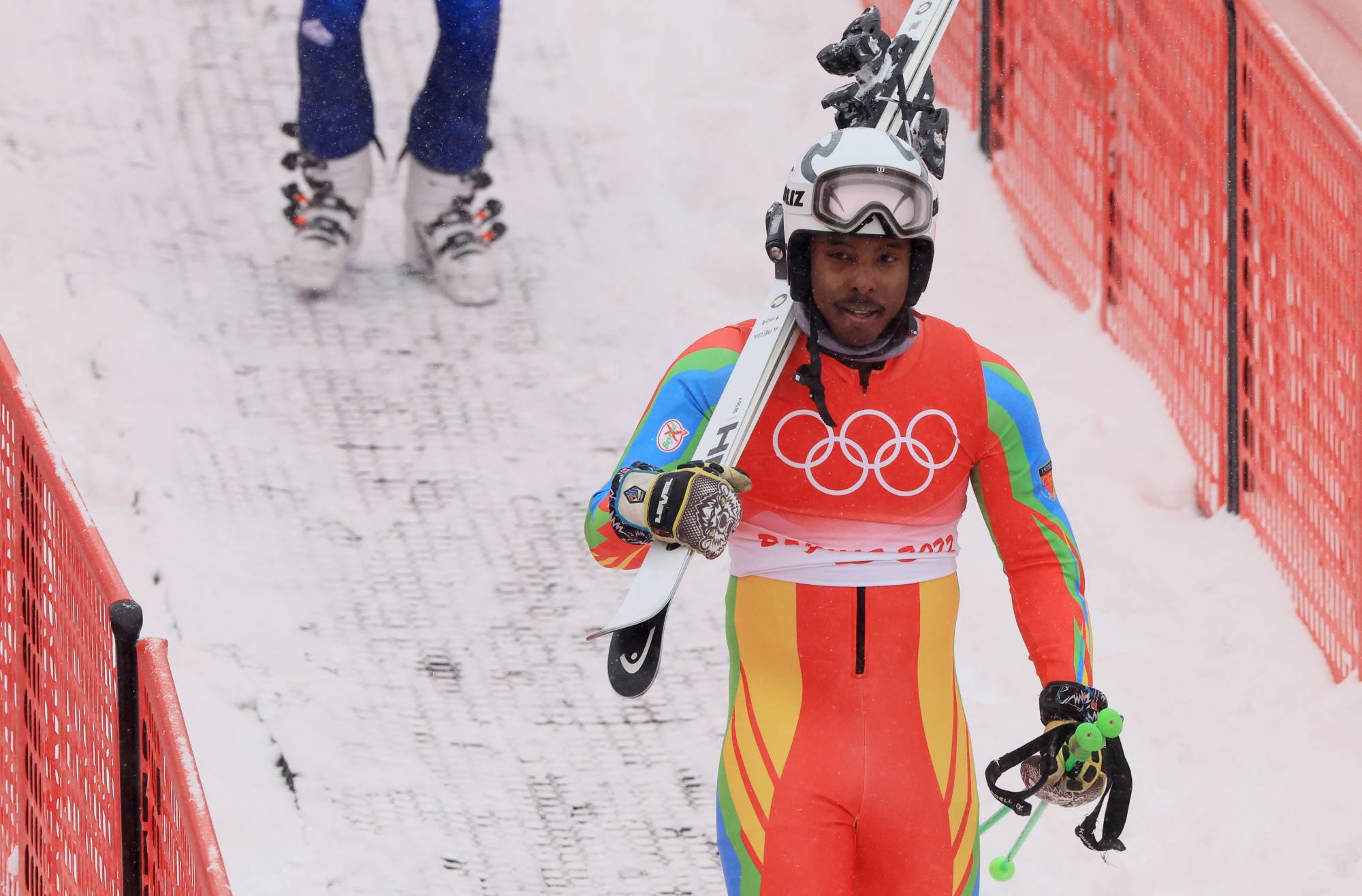 Shannon Abeda of Eritrea departs the slope after his men's giant slalom run at the 2022 Beijing Winter Olympics on Sunday. | REUTERS