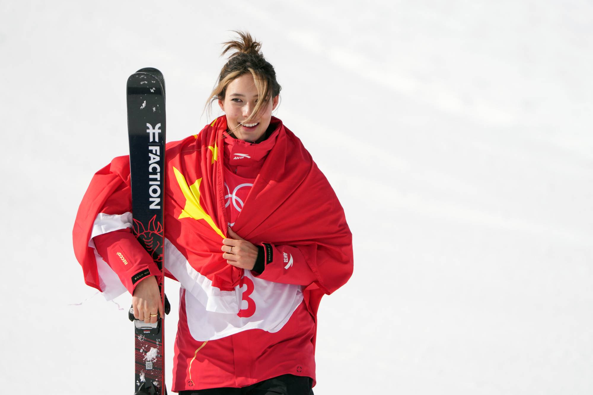 Eileen Gu celebrates her silver medal win for China in the freeski slopestyle competition on Tuesday. | CHANG W. LEE / THE NEW YORK TIMES