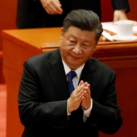 Chinese President Xi Jinping applauds at a meeting commemorating the 110th anniversary of Xinhai Revolution at the Great Hall of the People in Beijing on Oct. 9. | REUTERS