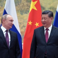 Russian President Vladimir Putin (left) and Chinese President Xi Jinping meet in Beijing, on Feb. 4.  | AFP-JIJI
