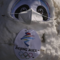 The Beijing 2022 Winter Olympics mascot Bing Dwen Dwen, wearing a mask and packed in snow, stands outside the ice hockey National Indoor Stadium in Beijing, on Wednesday. No new cases of COVID-19 were reported inside the Beijing Olympics \"closed loop\" on Thursday. | REUTERS