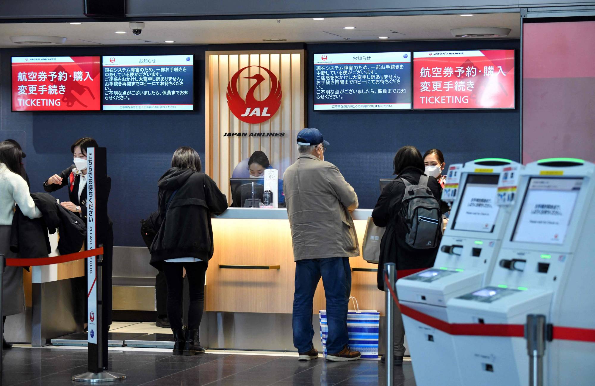 A check-in counter at Tokyo's Haneda Airport on Wednesday. As more people get infected with the highly transmissible omicron variant of the coronavirus, experts say there is no reason to keep the borders closed any longer.  | AFP-JIJI