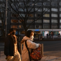 People walk in the Omotesando area of Tokyo earlier this month. Growth in consumer prices excluding fresh food in January slowed to 0.2% from a year earlier, compared with 0.5% in the previous month. | BLOOMBERG