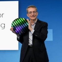 Intel CEO Pat Gelsinger holds a wafer as he speaks on stage at Intel\'s Investor Day in San Francisco on Thursday. | INTEL CORPORATION / VIA REUTERS    