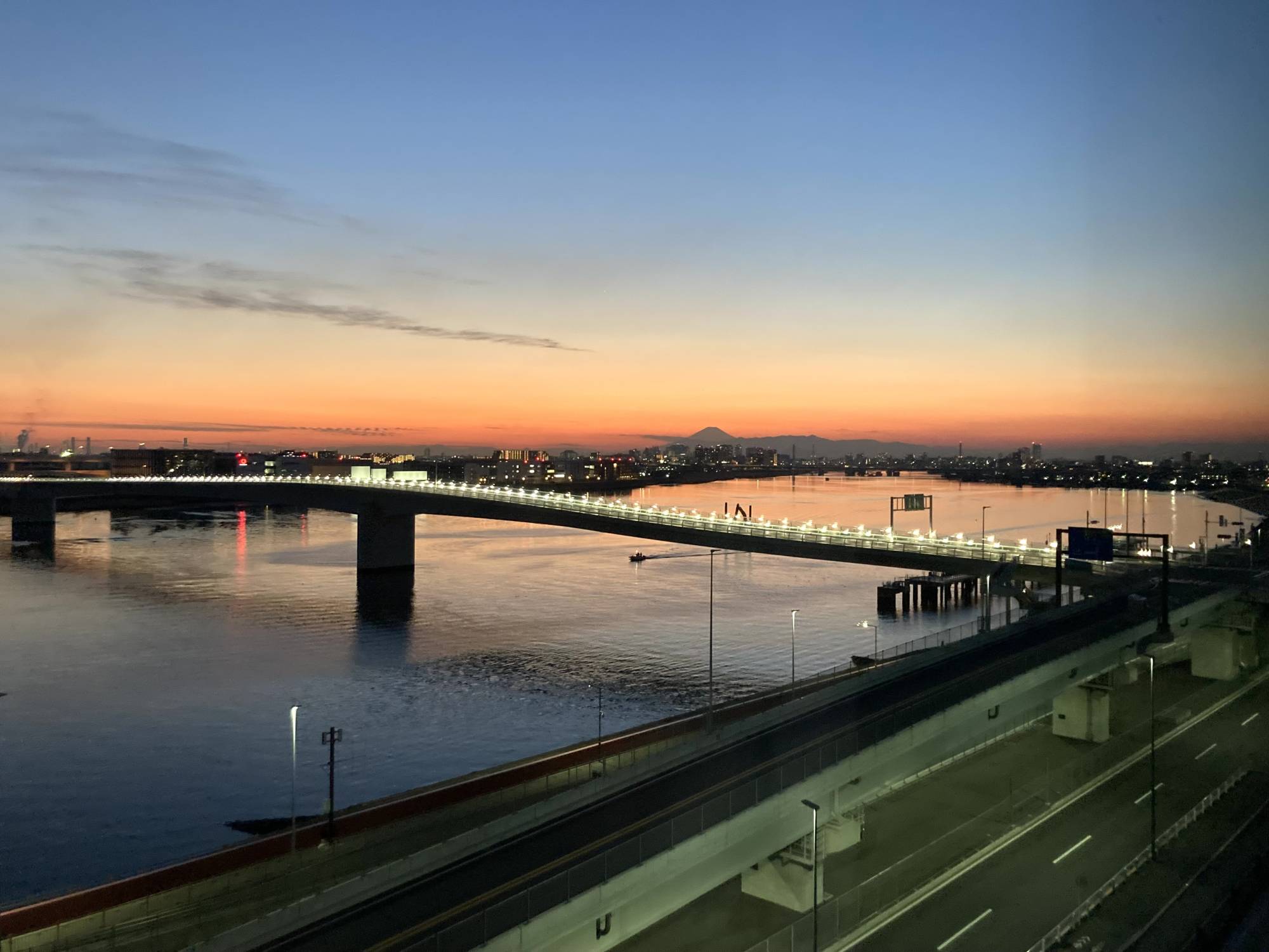 A view of the Tama River at sunset with Mount Fuji in the background. | REBECCA SAUNDERS