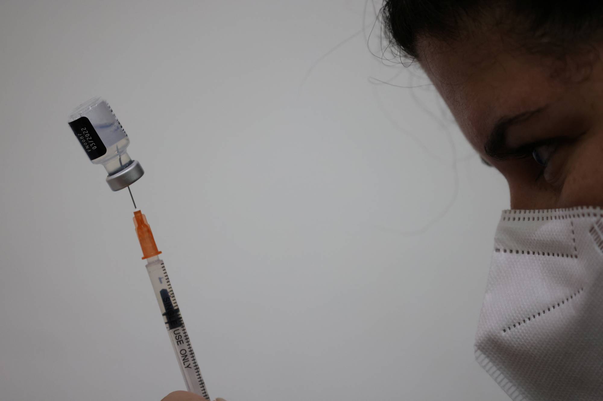 A health care worker prepares a Pfizer/BioNtech COVID-19 vaccine in Santiago, Chile, earlier this month.  | REUTERS