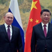 Russian President Vladimir Putin meets with Chinese President Xi Jinping in Beijing on Feb. 4, the opening day of the Winter Olympics hosted by China.  | SPUTNIK / KREMLIN / VIA REUTERS 