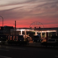 A Ferris wheel behind an Idemitsu Kosan Co. gas station at dusk in Tokyo in Nov., 2021 | BLOOMBERG