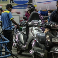 An attendant refuels a customer\'s motorcycle at a Bharat Petroleum Corp. gas station in Bengaluru, India.  | BLOOMBERG
