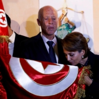 Then-Tunisian presidential candidate Kais Saied and his wife Ichraf Chebil react after exit poll results were announced in a second round runoff of the presidential election in Tunis, Tunisia Oct., 2019. | REUTERS