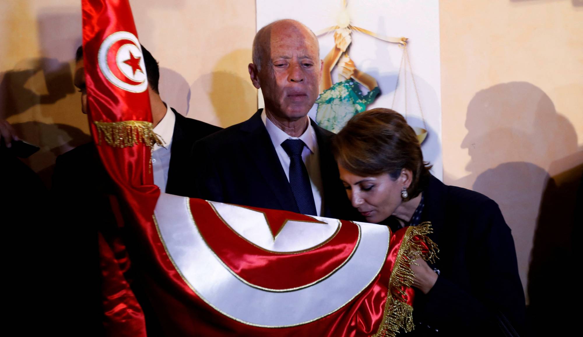 Then-Tunisian presidential candidate Kais Saied and his wife Ichraf Chebil react after exit poll results were announced in a second round runoff of the presidential election in Tunis, Tunisia Oct., 2019. | REUTERS