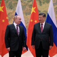 Russian President Vladimir Putin attends a meeting with Chinese President Xi Jinping in Beijing on Feb. 4. | REUTERS 