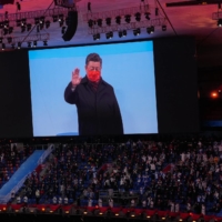 Chinese President Xi Jinping appears on a screen during the closing ceremony of the 2022 Beijing Winter Olympics on Sunday. | HIROKO MASUIKE / THE NEW YORK TIMES