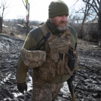 Ukrainian soldiers in Krymske, where mortar attacks from Russian-backed separatists fell through the night on Saturday  | TYLER HICKS / THE NEW YORK TIMES