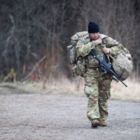 A U.S. Army soldier from the 82nd Airborne Division carries gear at an operating base near Przemysl, Poland, close to the Ukrainian border, on Monday. | REUTERS