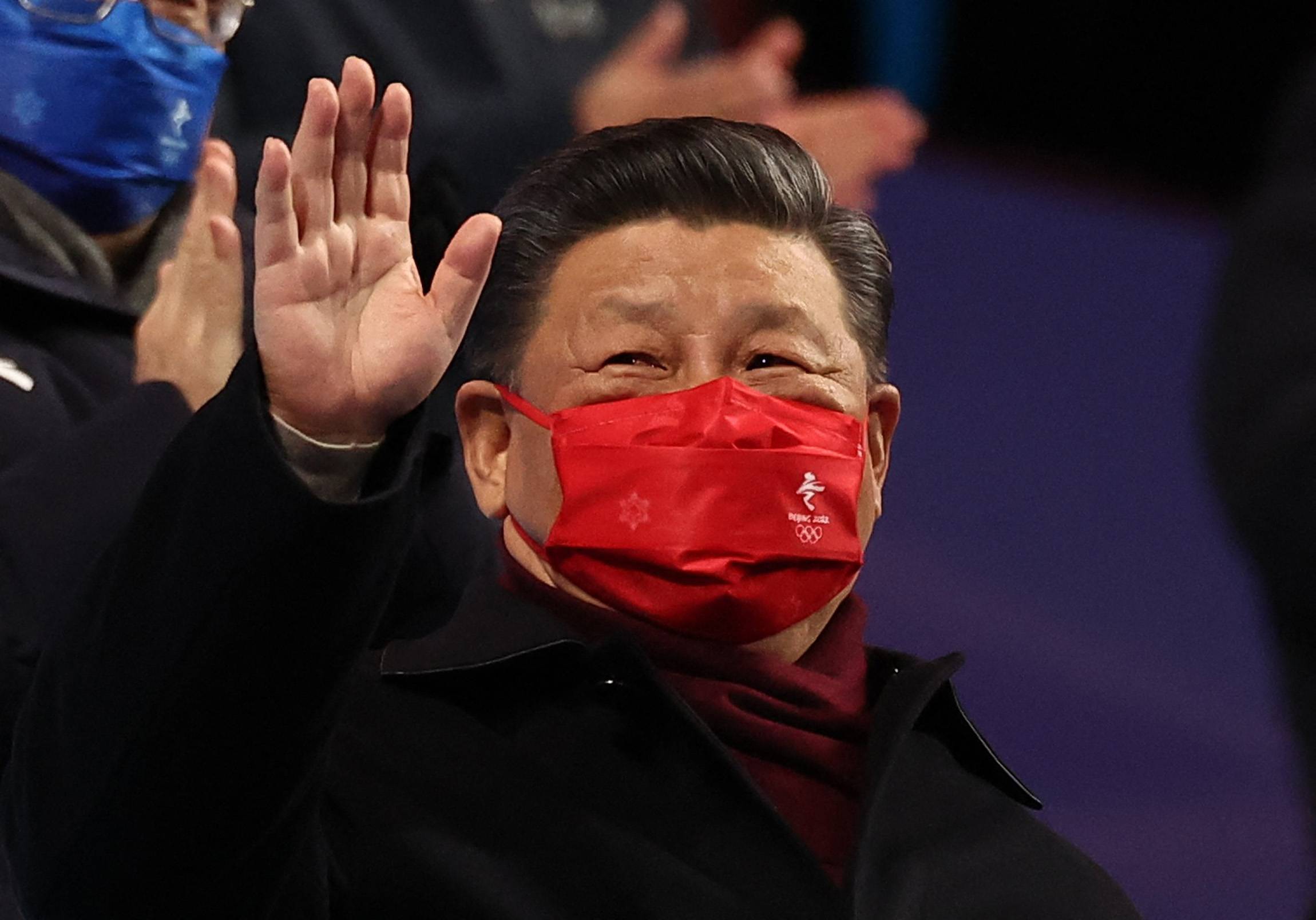 Chinese leader Xi Jinping waves during the closing ceremony of the 2022 Beijing Olympics on Sunday. | REUTERS