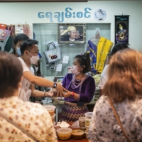 May Kyaw Soe Nyunt at her stall in Singapore | BLOOMBERG 