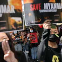 Myanmar citizens living in India attend a protest against the military coup in Myanmar in New Delhi on Tuesday.  | REUTERS 