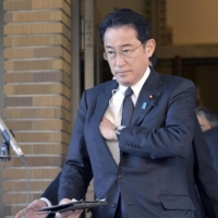 Prime Minister Fumio Kishida faces reporters Wednesday to announce a set of sanctions against Russia. | POOL / VIA KYODO