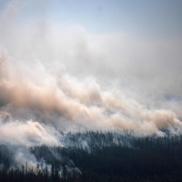Smoke rises from a forest fire outside the village of Berdigestyakh, in the republic of Sakha, Siberia. The number of major wildfires worldwide will rise sharply in coming decades due to global warming, and governments are ill-prepared for the death and destruction such megablazes trail in their wake, the U.N. warned Wednesday. | AFP-JIJI