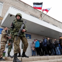 Militants of the self-proclaimed Donetsk People\'s Republic gather outside a military mobilization point in the separatist-controlled city of Donetsk, Ukraine, on Wednesday.    | REUTERS