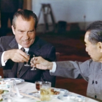U.S. President Richard Nixon toasts with Chinese Prime Minister Zhou Enlai at a banquet in Beijing during his official visit in February 1972. Communist China has gained substantially more than the U.S. in economic terms from the opening of relations that the visit ushered in, but the U.S. has gained too. | AFP-JIJI