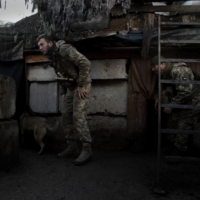 Ukrainian soldiers react to explosions in Zaitseve, Ukraine, on Wednesday. | TYLER HICKS / THE NEW YORK TIMES
