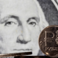 Russian ruble coins displayed in front of a U.S. dollar banknote. Efforts to make Russia less dependent on the dollar could blunt the impact of sanctions, at least for a while. |  REUTERS