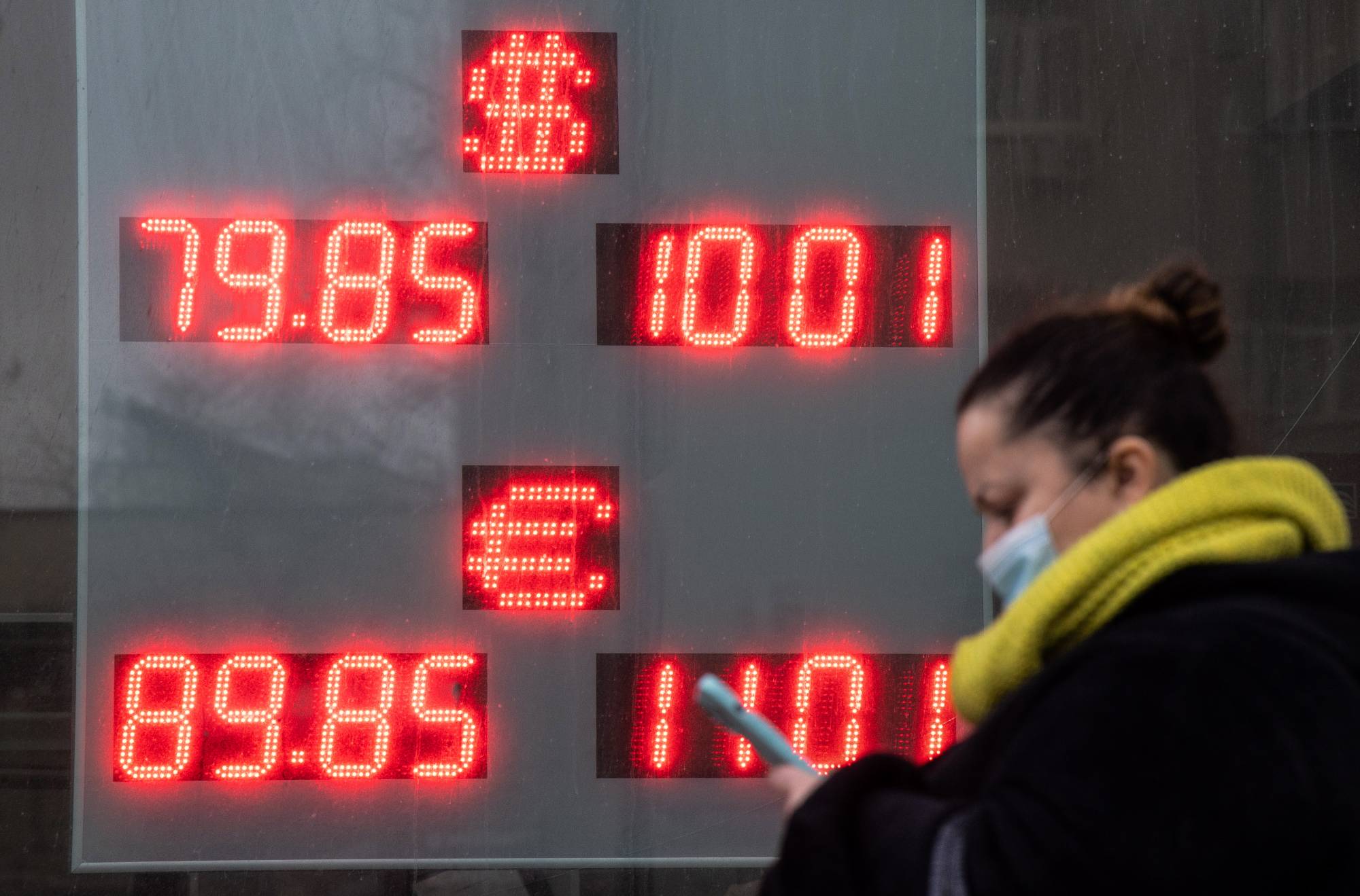A currency exchange rate sign in Moscow on Thursday. Russian's attack on Ukraine has prompted international condemnation and punishing sanctions on Moscow, sending markets tumbling worldwide. | Bloomberg
