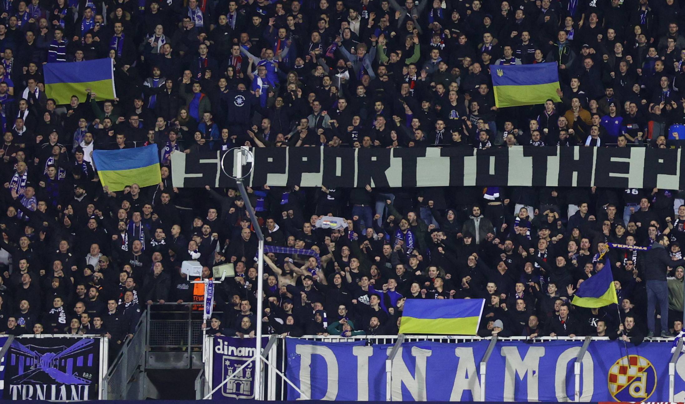 Fans hold up Ukrainian flags before a Europa League match between Dinamo Zagreb and Sevilla in Zagreb on Thursday. | REUTERS