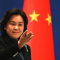 Chinese Foreign Ministry spokesperson Hua Chunying gives a new conference at the Foreign Ministry in Beijing on Thursday. China is walking a tightrope now between Russia and the West, seeing the Ukraine invasion as a good distraction from which it could benefit. | AFP-JIJI