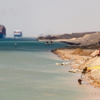 A ship passes through the Suez Canal as excavators work on expanding it, in Suez, Egypt, earlier this month.  | REUTERS