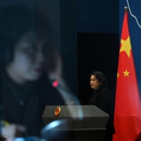 Chinese Foreign Ministry spokesperson Hua Chunying answers questions during a daily news  conference at the Foreign Ministry in Beijing on Thursday. | AFP-JIJI
