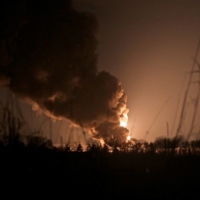 A burning oil depot reportedly hit by shelling near the military airbase in Vasylkiv, Ukraine. | REUTERS