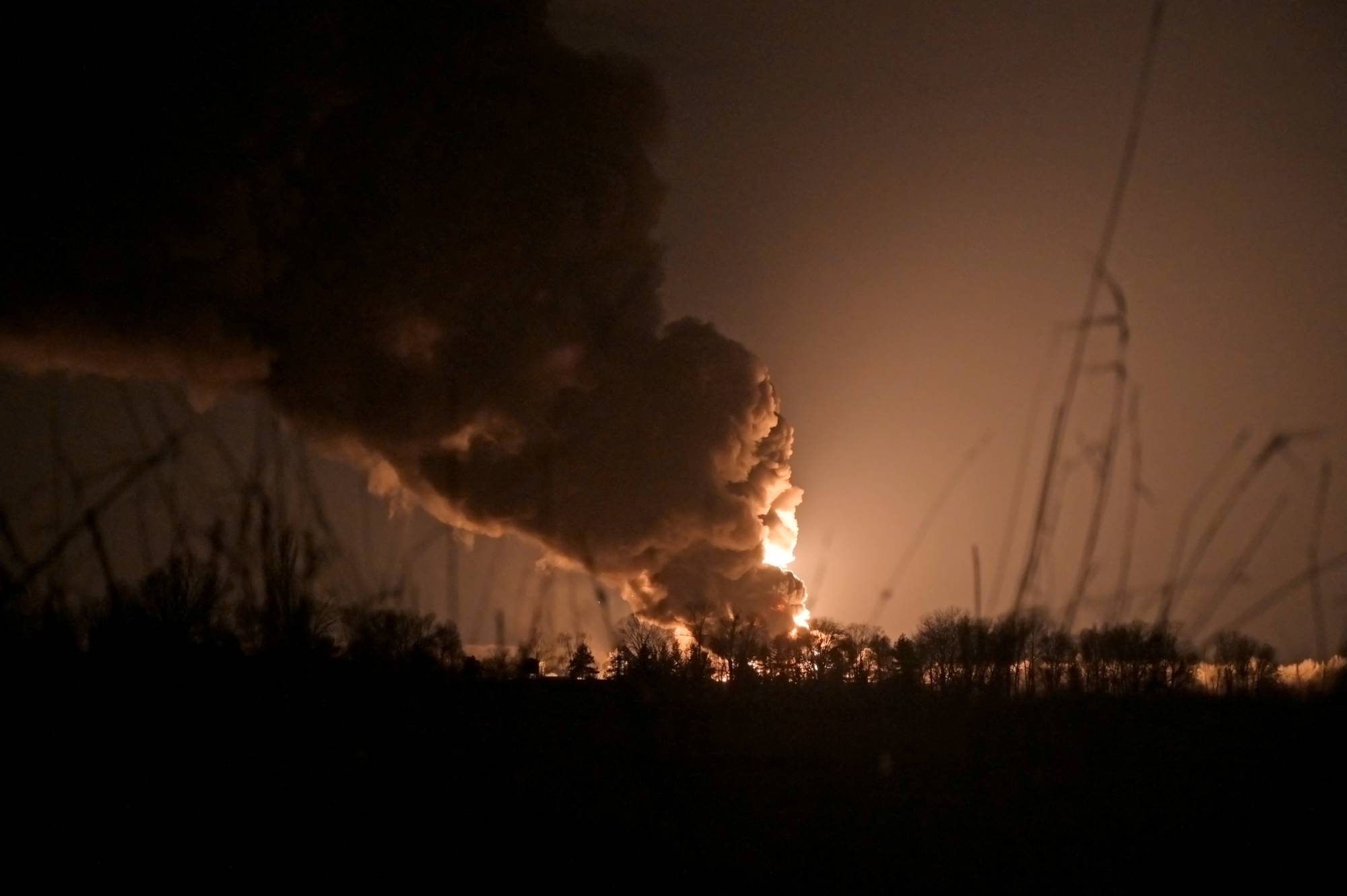 A burning oil depot reportedly hit by shelling near the military airbase in Vasylkiv, Ukraine. | REUTERS