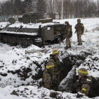 Ukrainian soldiers hold a position that was the site of a battle the day before with Russian forces on a highway leading into Kharkiv, Ukraine, on Friday.  | TYLER HICKS/THE NEW YORK TIMES