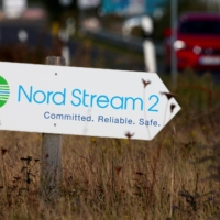 A road sign directs traffic towards the Nord Stream 2 gas line landfall facility entrance in Lubmin, Germany. | REUTERS 