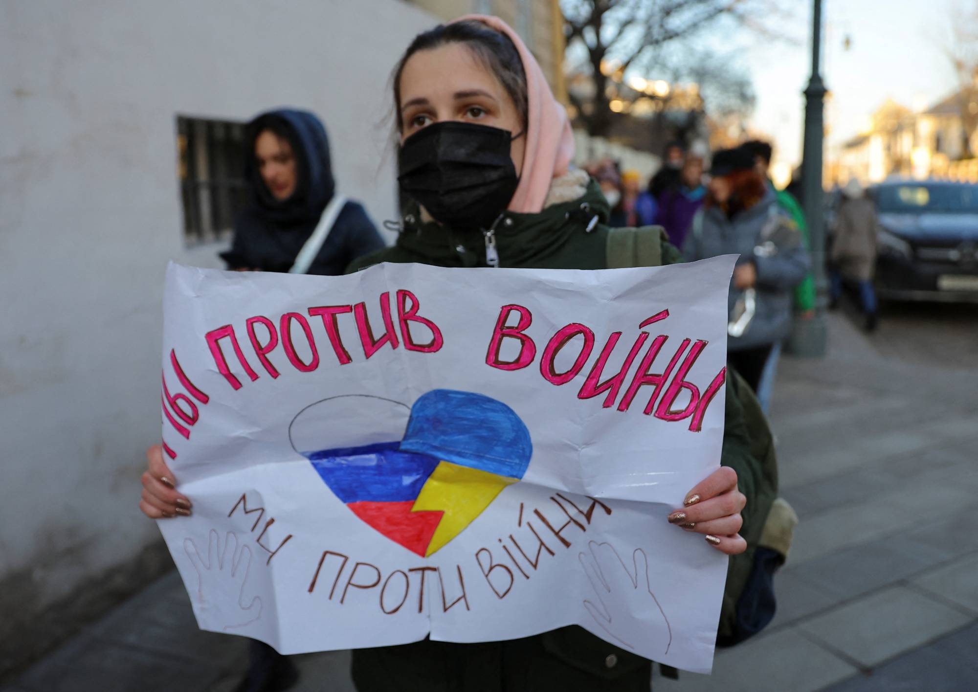 A person holds a sign that reads 'We are against war' in Moscow on Sunday during a protest against Russian invasion of Ukraine, after President Vladimir Putin authorized a massive military operation. | REUTERS