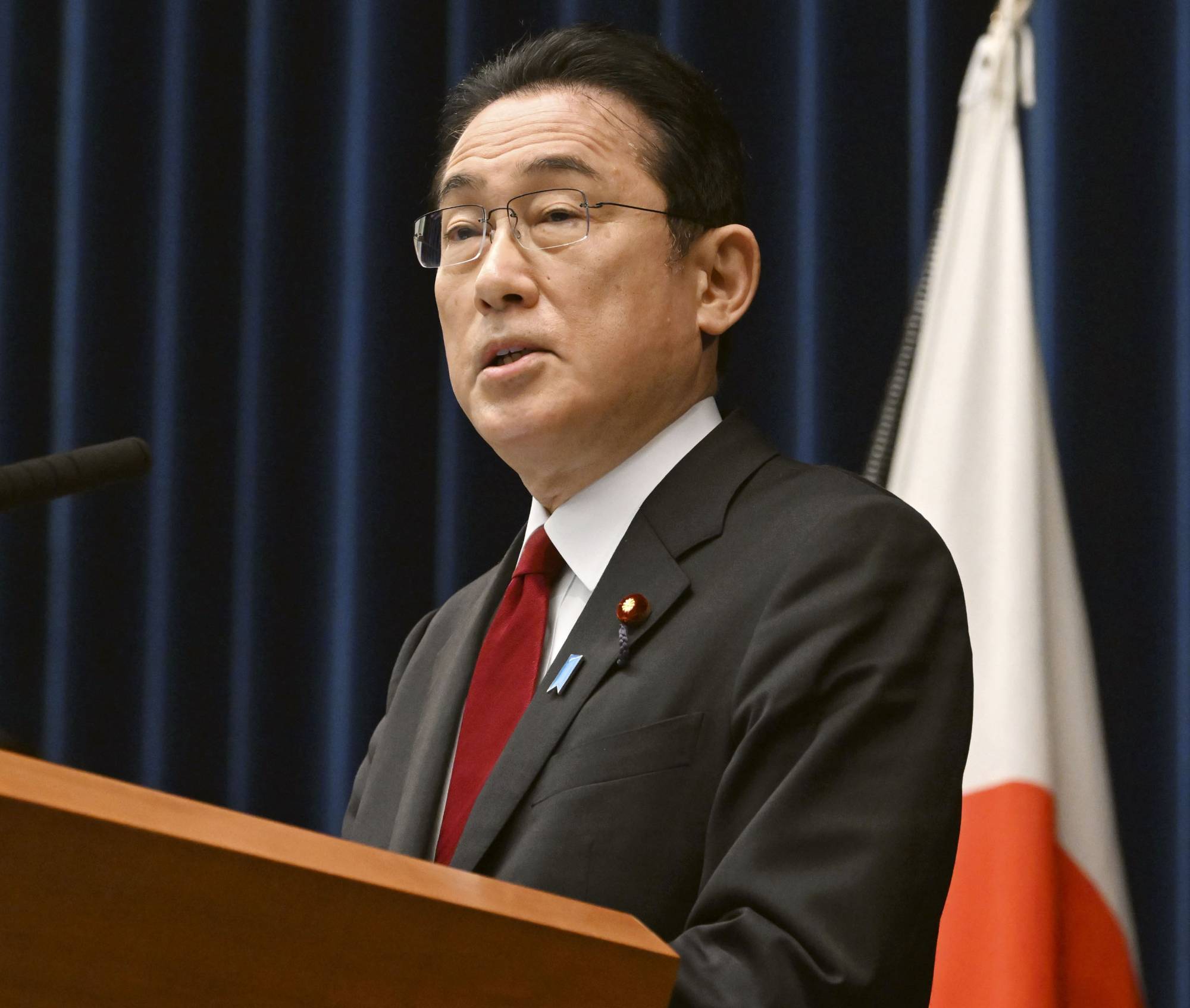 Prime Minister Fumio Kishida attends a news conference announcing sanctions on Russia over its invasion of Ukraine at his office in Tokyo on Friday. | KYODO