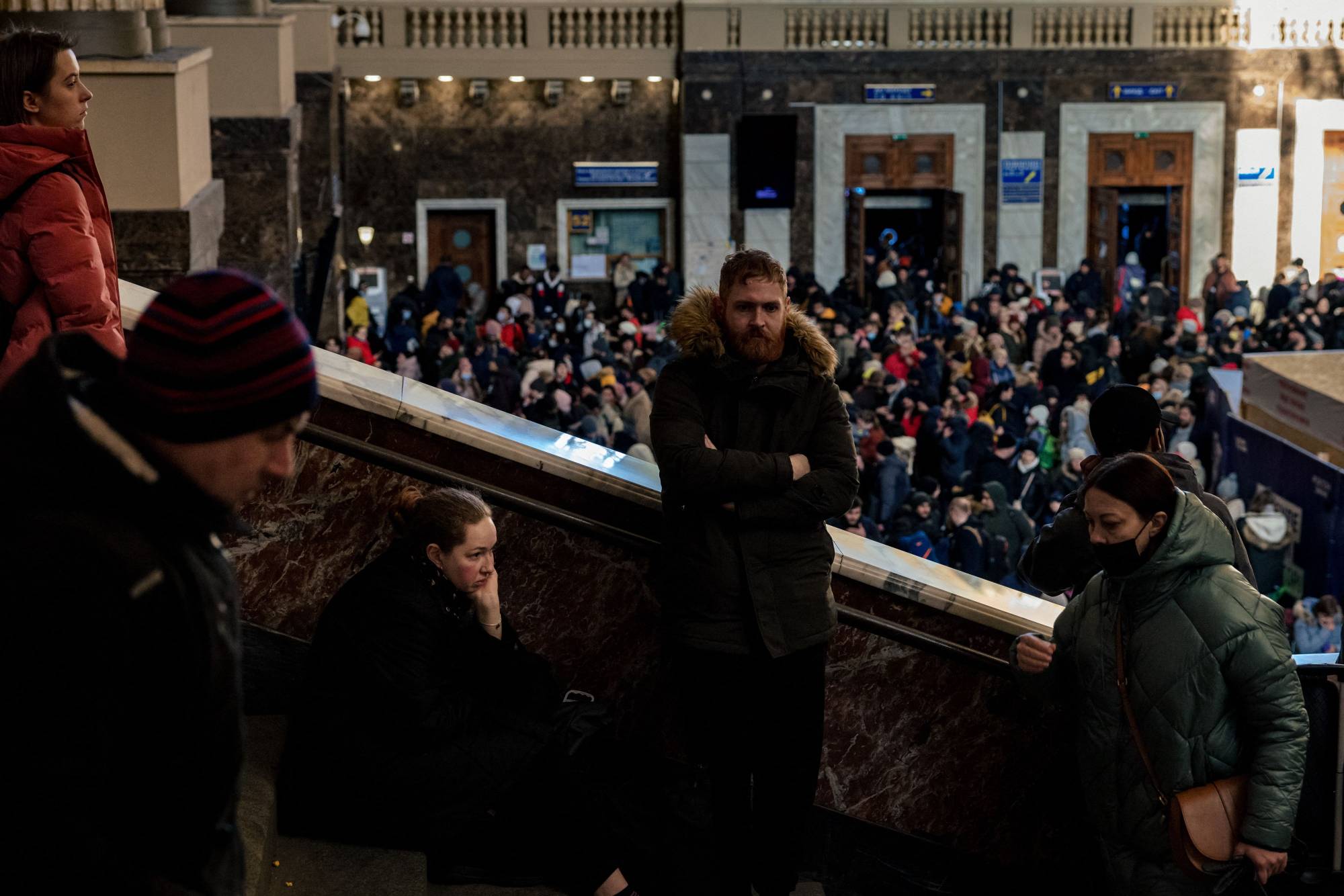 People wait to evacuate from Kyiv via rail at the Ukrainian capital's central train station on Monday. | AFP-JIJI