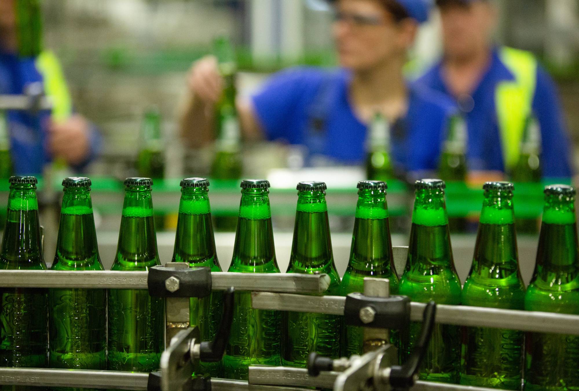 Bottles of Carlsberg beer on the production line at the Baltika Breweries plant in Saint Petersburg | BLOOMBERG