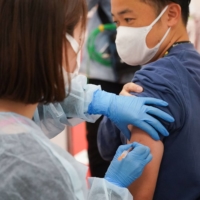 As of Monday, 19.3% of Japan\'s population has received a third COVID-19 vaccine dose. | BLOOMBERG