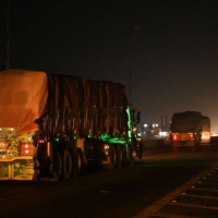 Afghan trucks carrying wheat on the road to Lahore, after crossing the Pakistan-India border. All 34 Afghan provinces are facing crisis or emergency levels of acute food insecurity. | AFP-JIJI