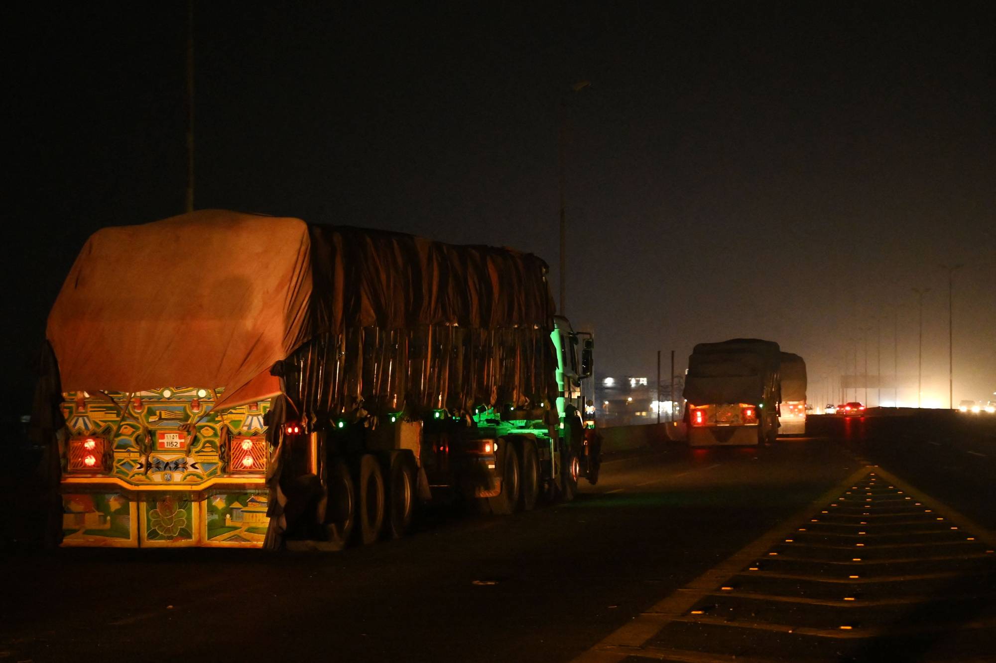 Afghan trucks carrying wheat on the road to Lahore, after crossing the Pakistan-India border. All 34 Afghan provinces are facing crisis or emergency levels of acute food insecurity. | AFP-JIJI