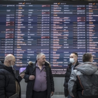 The departures board displayed flight cancellations at Sheremetyevo Airport in Moscow on Monday. | SERGEY PONOMAREV / THE NEW YORK TIMES